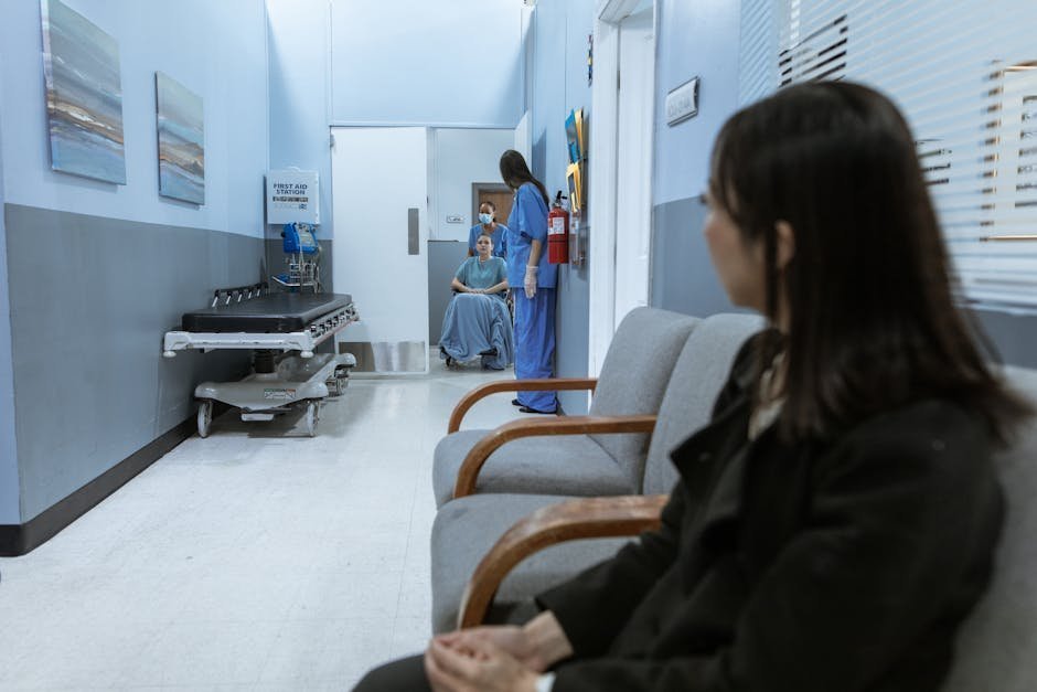Hospital corridor at night with chaplain and grieving widow holding paperwork after sudden loss