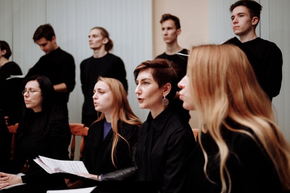 Community choir members standing in rows during a rehearsal in a church hall