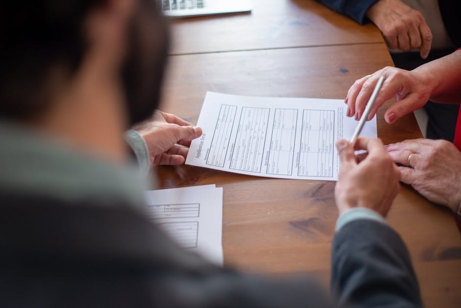 Attorney reviewing a banker's box of insurance denial letters and appeal documents in a law office