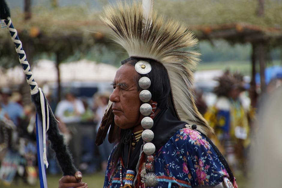 Native American patient and counselor in a tribal health clinic with traditional healing items on a desk