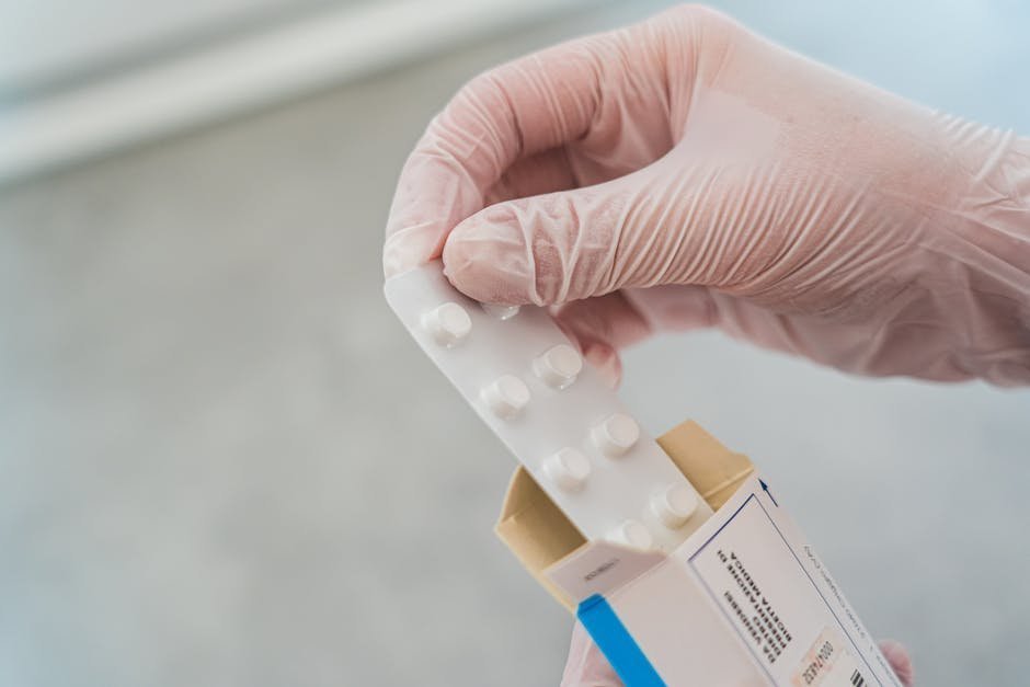 Nurse handing a small package of buprenorphine film to a patient sitting on a hospital bed