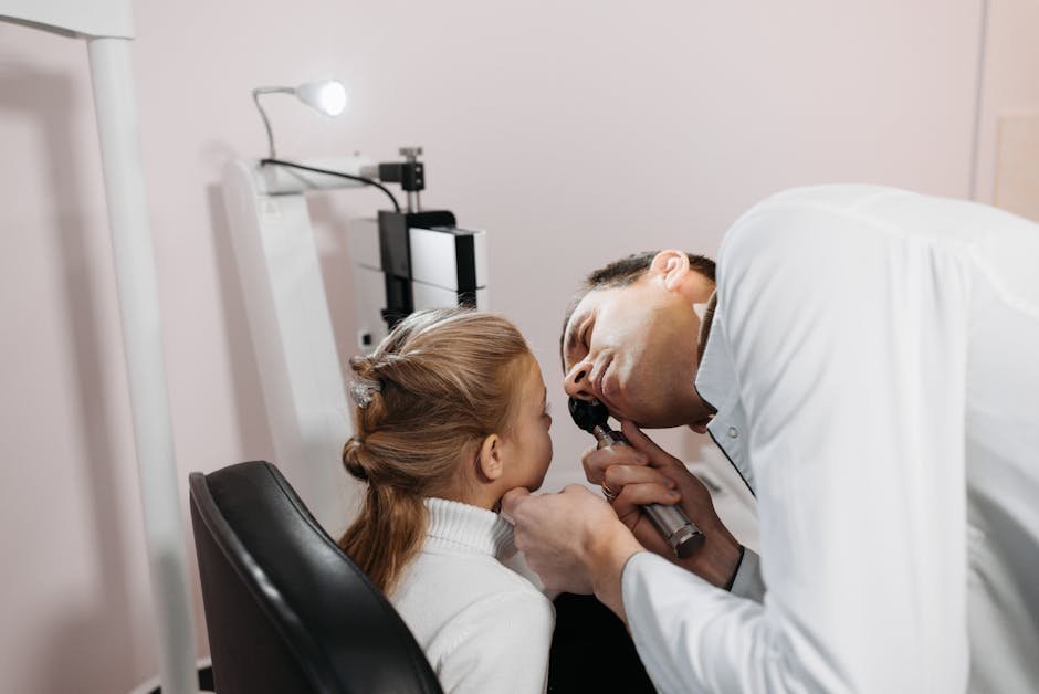 Pediatric sleep specialist examining child with parent in clinic