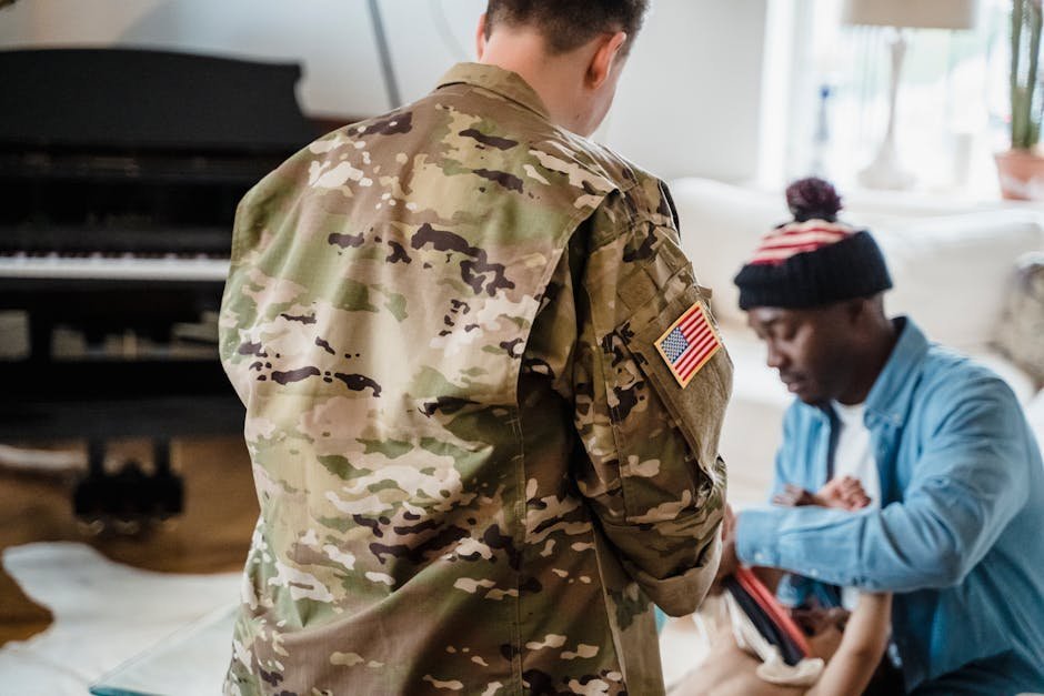 Veteran in civilian clothing speaking with a counsellor in a VA medical centre hallway